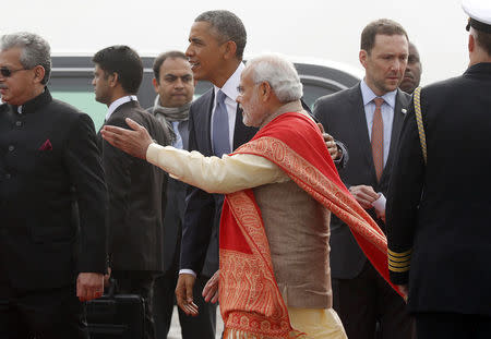 U.S. President Barack Obama is greeted by Prime Minister Narendra Modi as he arrives at Air Force Station Palam, New Delhi January 25, 2015. REUTERS/Jim Bourg