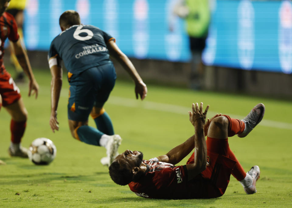 Darnell King of Phoenix Rising FC reacts after colliding with San Diego Loyal's Charlie Adams (6) during a USL soccer match on Sunday, Oct. 22, 2023, in San Diego. (K.C. Alfred/The San Diego Union-Tribune via AP)