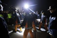 FILE - In this April 19, 2014 photo, the body of a passenger aboard the ferry Sewol which sank in the water off the South Korea's southern coast, is carried by rescue workers upon arrival at a port in Jindo, south of Seoul. Jokes and concerts are out. So are school field trips and boisterous cheering at baseball games. As South Korea mourns one of its worst ever disasters, a ferry sinking on April 16 that will likely result in the death of more than 300 people, most of them high school kids, anything deemed frivolous or fun is frowned upon, and the backlash for breaking this collective somber mood can be harsh. (AP Photo/Lee Jin-man, File)