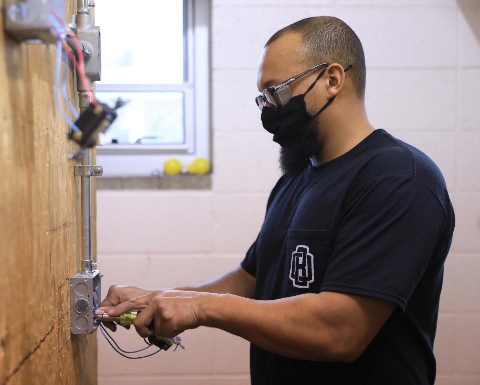 Mykel Blanks works on wiring a series of receptacles during class at Hudson Valley Community College in Troy on February 22, 2022. Blanks is a student in the college's Electrical Construction and Maintenance program.