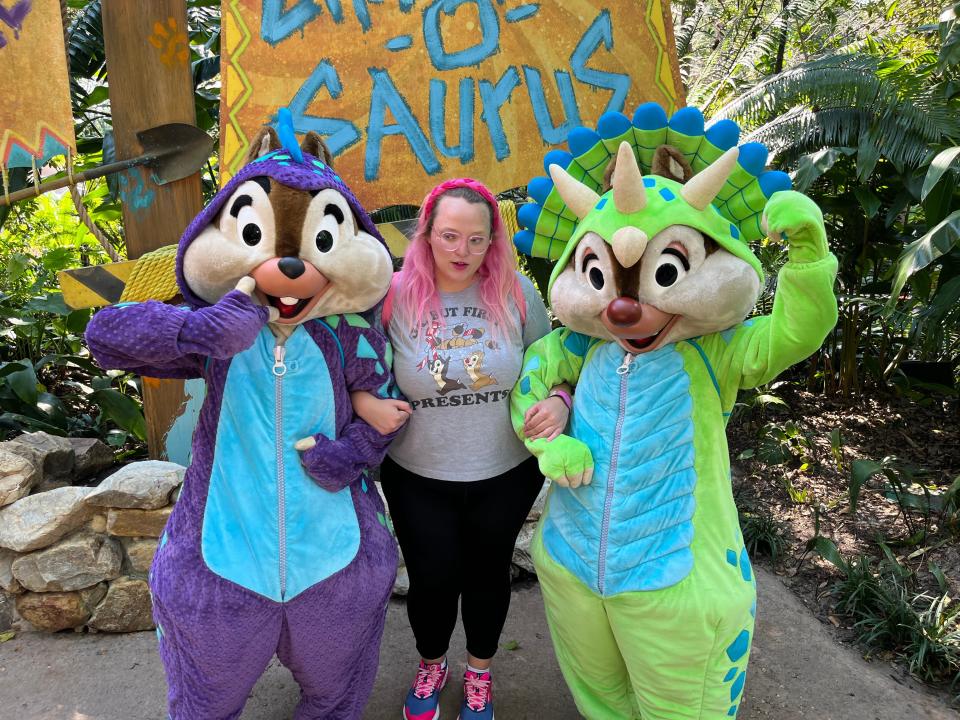 casey posing for a photo with dino chip and dale at animal kingdom in disney world