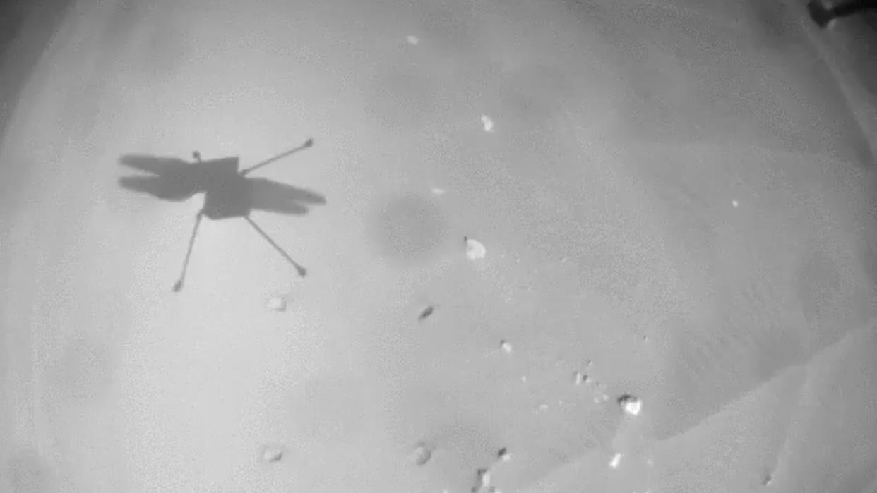  shadow of helicopter on ground of mars in black and white 