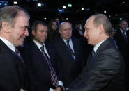 FILE - Then-Russian Prime Minister Vladimir Putin, right, congratulates members of the Russian delegation, from left: conductor Valery Gergiyev, businessman Roman Abramovich and Nizhny Novgorod Gov. Valery Shantsev; after it was announced that Russia would host the 2018 soccer World Cup in Zurich, Switzerland, Dec. 2, 2010. When Putin came to power in 2000, the outside world viewed Russia's "oligarchs" as men who whose vast wealth made them almost shadow rulers. Putin was reported to have told about two dozen of the men regarded as the top oligarchs in a meeting later in 2000 that if they stayed out of politics, their wealth wouldn't be touched. (AP Photo/Alexei Nikolsky, Pool, File)