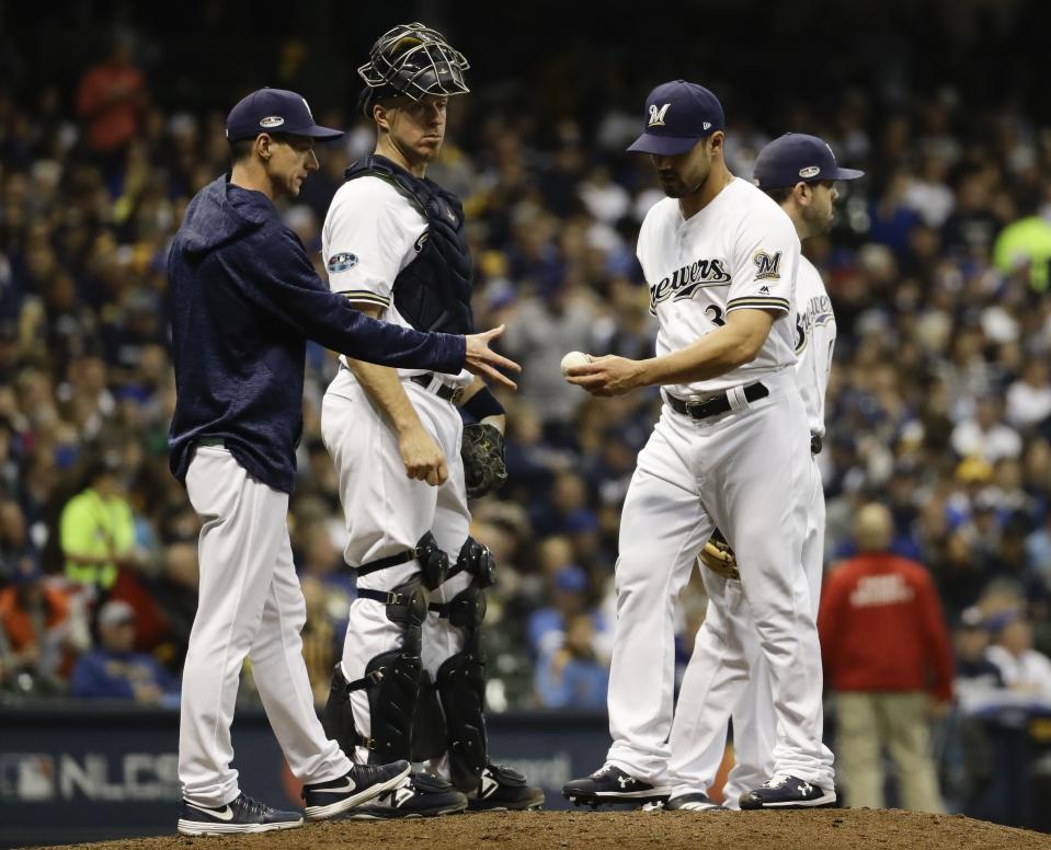 Milwaukee Brewers manager Craig Counsell takes relief pitcher Xavier Cedeno out of the game during the sixth inning of Game 7 of the National League Championship Series baseball game against the Los Angeles Dodgers Saturday, Oct. 20, 2018, in Milwaukee. (AP Photo/Matt Slocum)