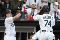 Chicago White Sox's Eloy Jimenez is greeted at the dugout by Andrew Vaughn after Jimenez's RBI sacrifice fly off Los Angeles Angels starting pitcher Tyler Anderson during the first inning of a baseball game Tuesday, May 30, 2023, in Chicago. (AP Photo/Charles Rex Arbogast)