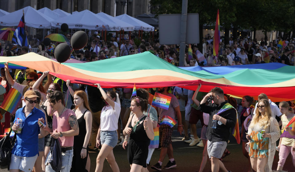 People take part in the Equality Parade, the largest gay pride parade in central and eastern Europe, in Warsaw, Poland, Saturday June 19, 2021. The event has returned this year after a pandemic-induced break last year and amid a backlash in Poland and Hungary against LGBT rights.(AP Photo/Czarek Sokolowski)