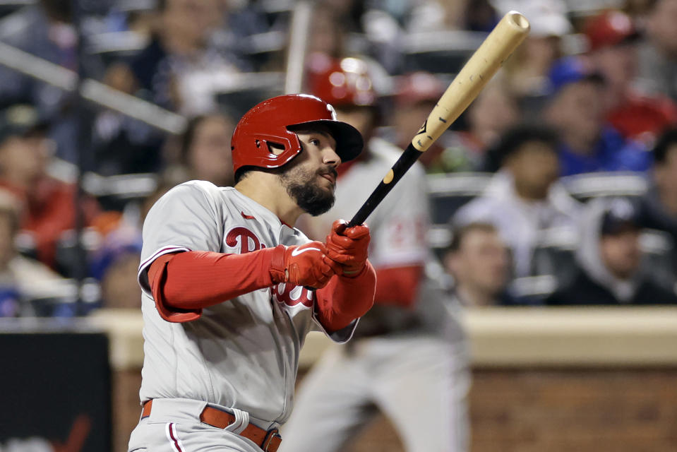 Philadelphia Phillies' Kyle Schwarber watches his two-run home run during the seventh inning of a baseball game against the New York Mets on Saturday, April 30, 2022, in New York. (AP Photo/Adam Hunger)