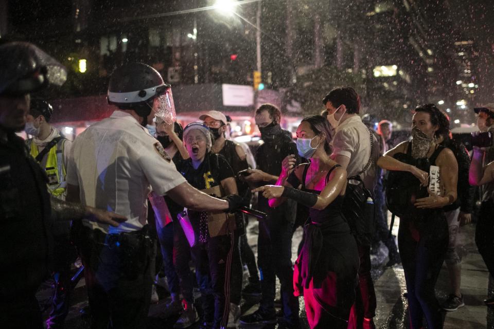 Police advance to arrest some protesters after they broke a curfew Wednesday, June 3, 2020, in New York, by marching through Manhattan during a solidarity rally calling for justice over the death of George Floyd. Floyd died after being restrained by Minneapolis police officers on May 25. (AP Photo/Wong Maye-E)