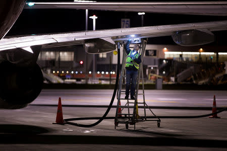 Jet fuel is siphoned directly between two Qantas aircraft on the tarmac of Auckland Airport in New Zealand, September 21, 2017, during fuel shortages which have affected New Zealand's aviation sector. Qantas/Ollie Dale/Handout via REUTERS