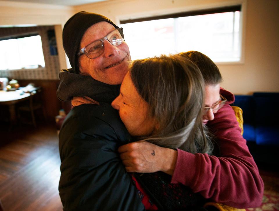 Steve Connelly, left, shares an embrace with death doula Amy May and his wife Becky Jones after a counseling session in January. Steve is battling pancreatic cancer.