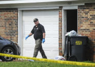 A Morgan County, Ala. investigator works at the scene, Friday, June 5, 2020, in Valhermoso Springs, Ala., where numerous people were found fatally shot. Deputies responding to a call about a shooting in Alabama found seven people dead inside a home that had been set afire early Friday, authorities said. (Jeronimo Nisa/The Decatur Daily via AP)