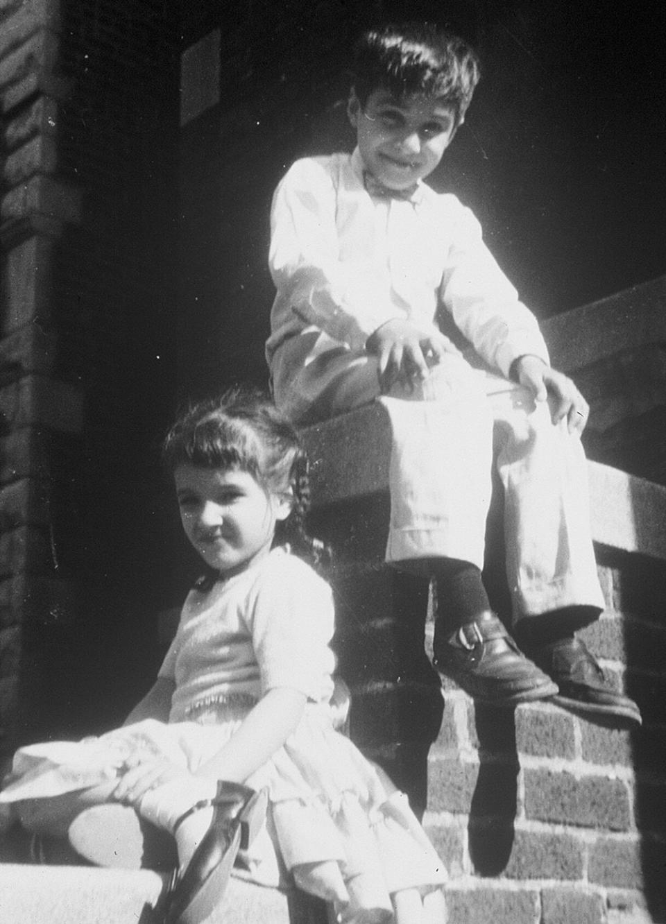 Sandra Cisneros and her brother sitting on the steps outside her grandfather’s house.
