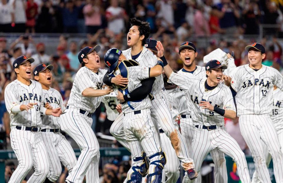 Japan pitcher Shohei Ohtani (16) celebrates with his teammates after defeating the United States in the championship game at the World Baseball Classic at loanDepot Park on Tuesday, March 21, 2023, in Miami, Fla.