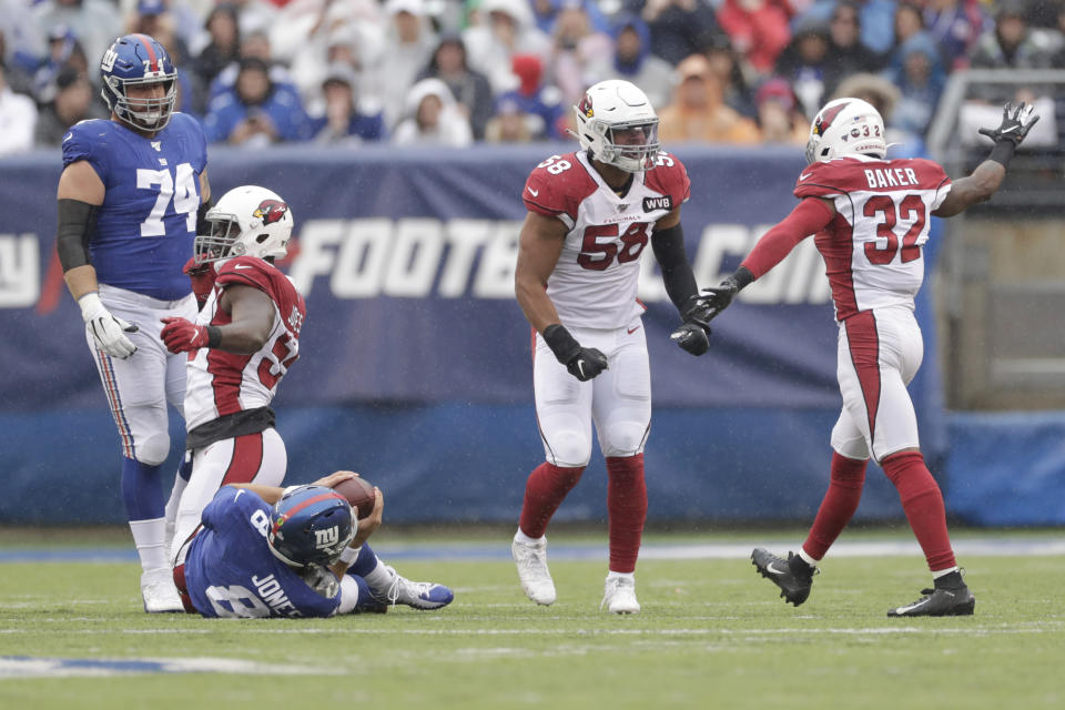 Arizona Cardinals' Jordan Hicks (58), second from right, and Budda Baker, right, celebrate a sack during the first half of an NFL football game against the New York Giants, Sunday, Oct. 20, 2019, in East Rutherford, N.J. (AP Photo/Adam Hunger)