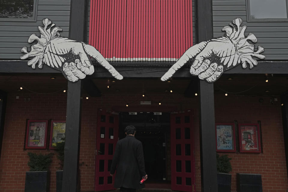 A man walks in the Other Place theater, in Stratford-upon-Avon, Warwickshire, England, Tuesday, Feb. 28, 2023. The foyer of the Other Place theater in Shakespeare's birthplace of Stratford-upon-Avon is a cozy refuge from winter. One day a week the theater becomes a "warm hub," set up by the Royal Shakespeare Company to welcome people who may be struggling to heat their homes because of sky-high energy prices. (AP Photo/Kin Cheung)