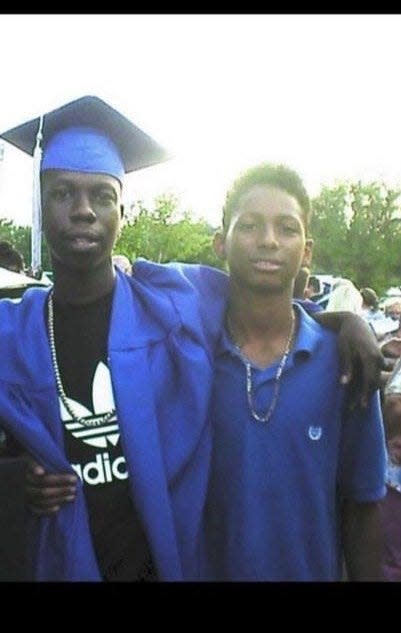 Jalen Richardson, left, stands beside his cousin, Malique Richardson, right, during a high school graduation. Malique Richardson was gunned down at a Tallahassee apartment complex Friday, July 8, 2022.