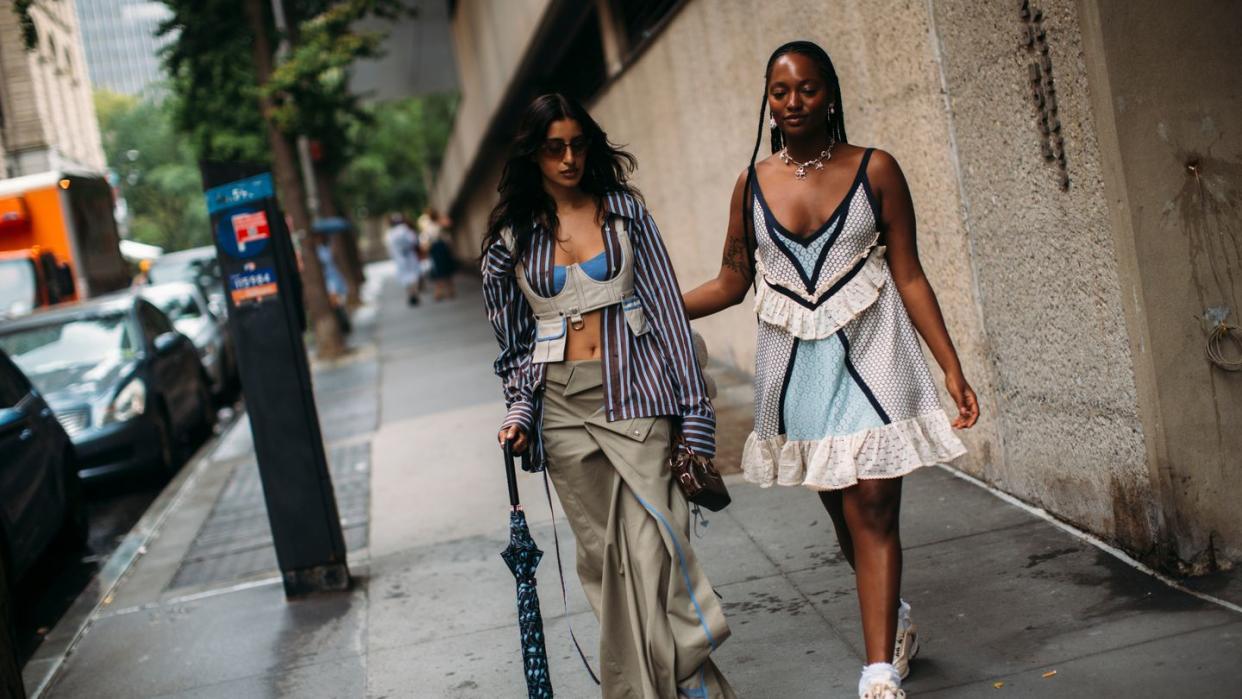 two women walking down a sidewalk