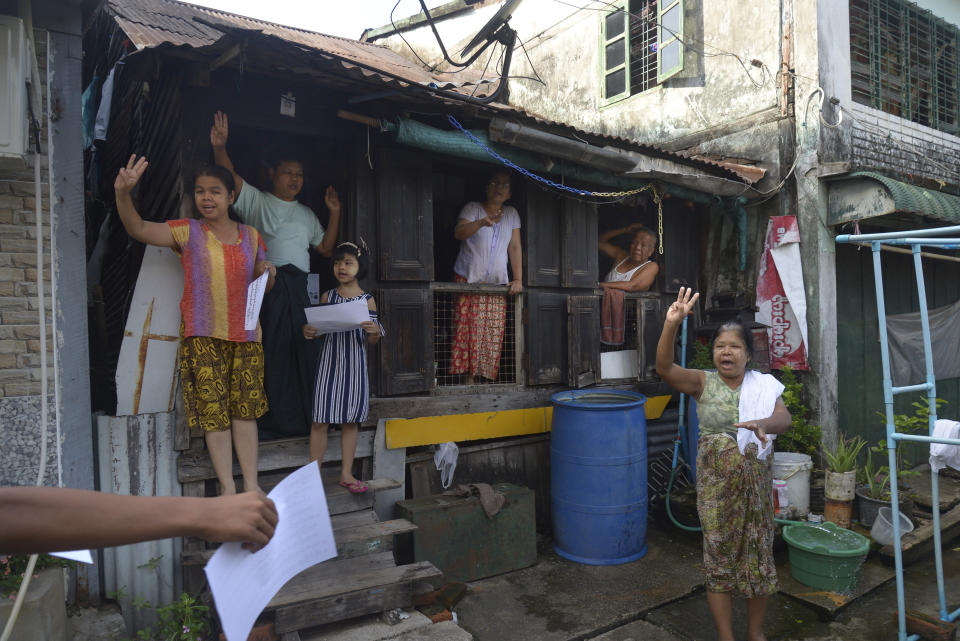 Residents flash the three-finger salute of resistance during a demonstration in Yangon, Myanmar on Wednesday, April 7, 2021. Protesters continue to hold daily demonstrations in some parts of Myanmar despite threats from government forces of arrest and dispersal as they rally against the Feb. 1 military coup that ousted the civilian government of Aung San Suu Kyi. (AP Photo)