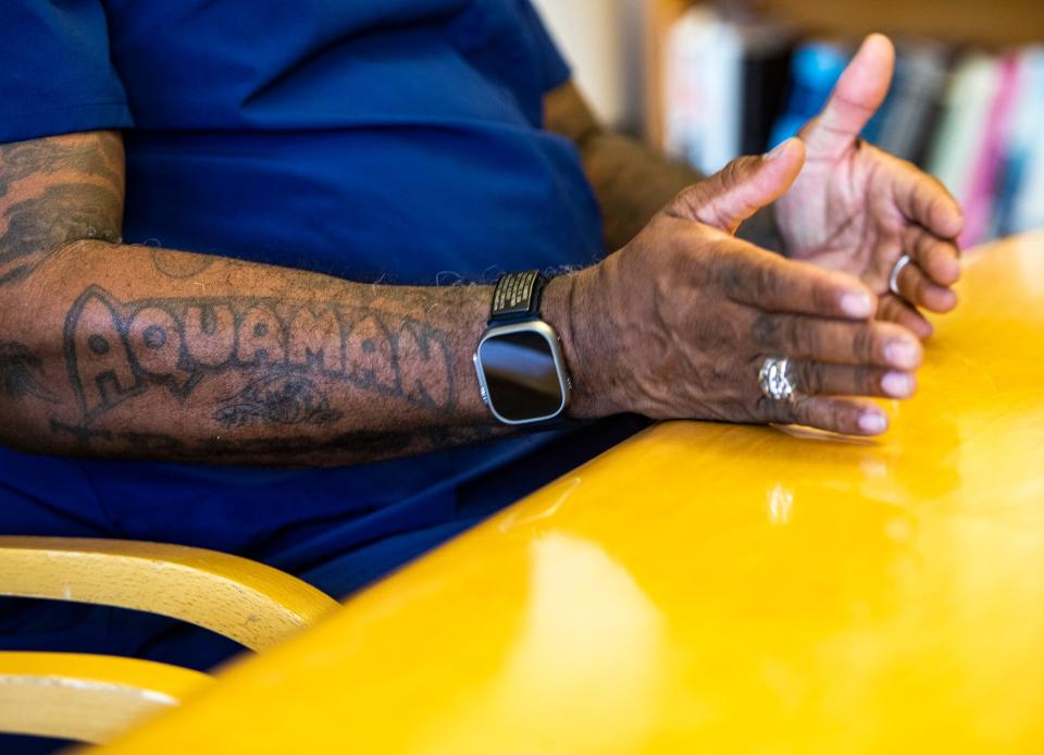 A tattoo of the word "Aquaman" is seen on André Chambers' arm as he sits for an interview at the Betty Ford Center in Rancho Mirage, Calif., Thursday, July 6, 2023.