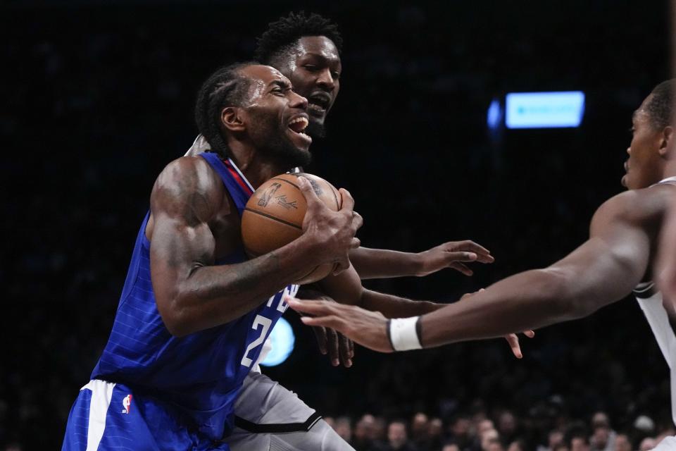 LA Clippers' Kawhi Leonard (2) drives past Brooklyn Nets' Dorian Finney-Smith and Lonnie Walker IV, right, during the second half of an NBA basketball game Wednesday, Nov. 8, 2023, in New York. The Nets won 100-93. (AP Photo/Frank Franklin II)