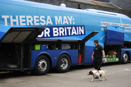 A police sniffer dog is used to check Britain's Prime Minister Theresa May's campaign bus as she attends an election campaign event in Wolverhampton, May 30, 2017. REUTERS/Leon Neal/Pool