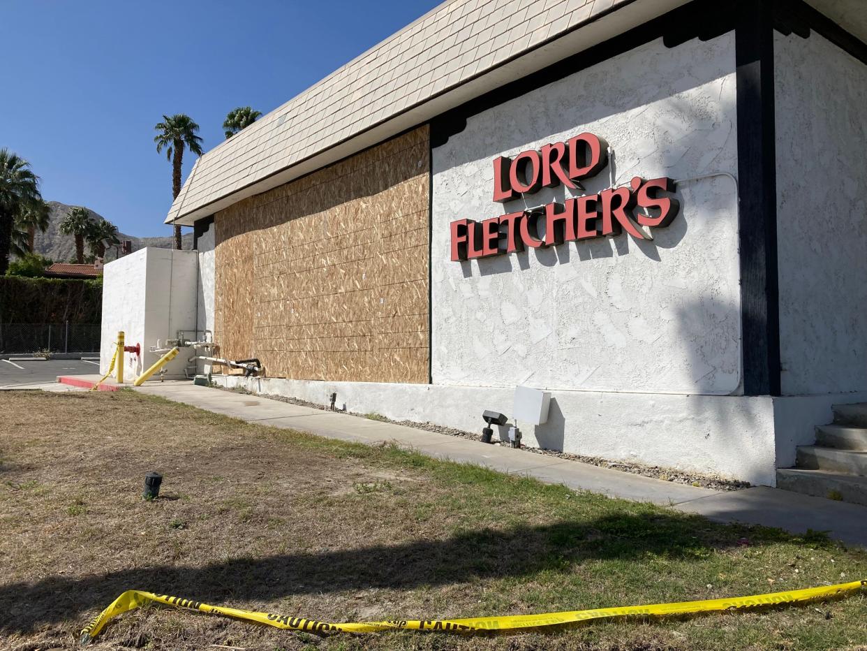 An exterior wall of the old Lord Fletcher's building was destroyed after a car crashed into it early Tuesday morning. The wall had been boarded up by Wednesday morning.