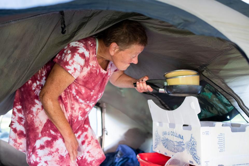 “Make them cook. Make them do laundry. They don’t know what it feels like,” said Kimberly Morris who puts away her dishes in her tent in Tussing Park on April 10, 2024 in Grants Pass, Ore.