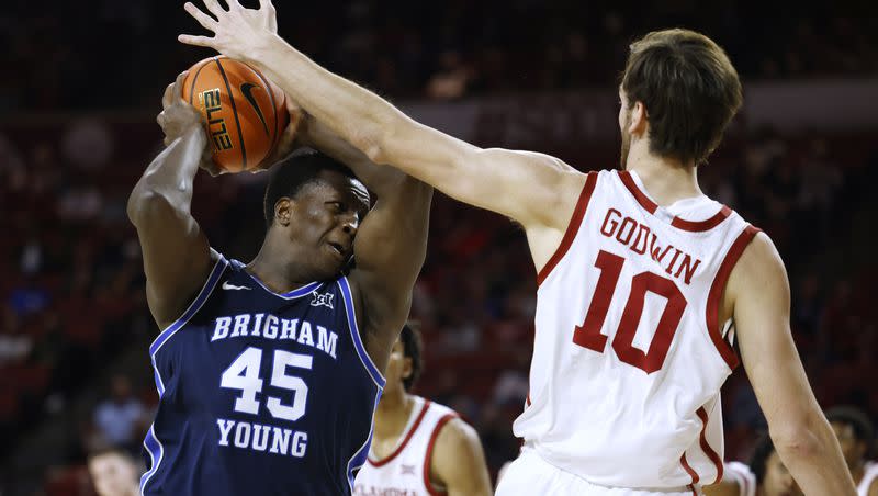 BYU forward Fousseyni Traore (45) is defended by Oklahoma forward Sam Godwin (10) during the first half of an NCAA college basketball game Tuesday, Feb. 6, 2024, in Norman, Okla.