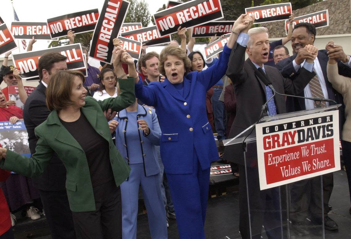 Sens. Barbara Boxer and Dianne Feinstein, center, join Gov. Gray Davis in a labor rally at the Teamsters hall in Oakland on Oct. 4, 2003. The rally was part of Governor Davis’ ”Just Say No” campaign tour against the recall campaign. Rev. Jesse Jackson stands at right.