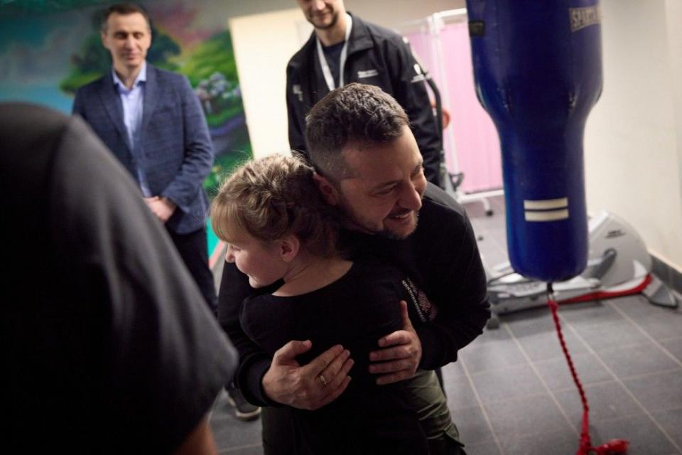 President Volodymyr Zelensky hugs Maryna Ponomarova during his visit to children undergoing rehabilitation at Ohmatdyt hospital in Kyiv, Ukraine on Dec. 6, 2023. (President's Office)