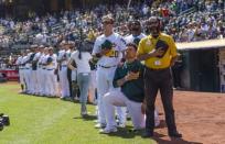 Sep 24, 2017; Oakland, CA, USA; Oakland Athletics catcher Bruce Maxwell (13) kneels during the national anthem as right fielder Mark Canha (20) places his hand on his shoulder before a game against the Texas Rangers at Oakland Coliseum. Mandatory Credit: John Hefti-USA TODAY Sports