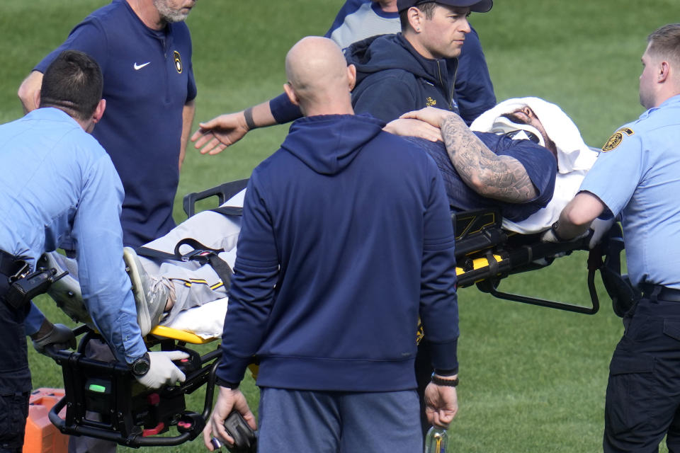 Milwaukee Brewers pitcher Jakob Junis is wheeled to an ambulance in the outfield of PNC Park after being hit by a ball during batting practice before a baseball game against the Pittsburgh Pirates in Pittsburgh, Monday, April 22, 2024. (AP Photo/Gene J. Puskar)