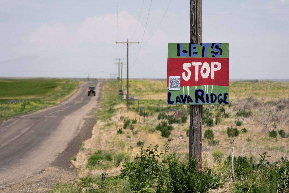 A tractor travels down Hunt Road in front of a “Let’s Stop Lava Ridge” sign near the historic site.