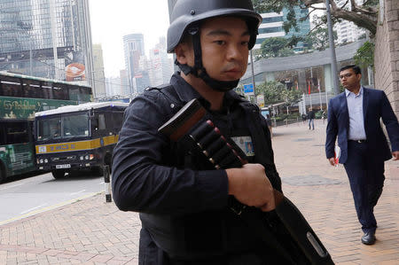 An armed policeman guards the entrance as a prison car carrying British former banker Rurik Jutting enters High Court to launch his appeal, in Hong Kong, China December 12, 2017. REUTERS/Tyrone Siu