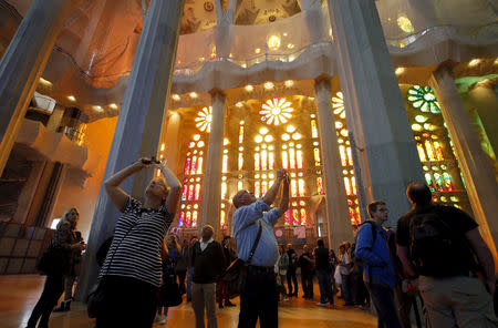 FILE PHOTO: Visitors take pictures inside the Basilica Sagrada Familia, which was designed by Antoni Gaudi, in Barcelona, Spain, October 21, 2015. REUTERS/Albert Gea/File Photo