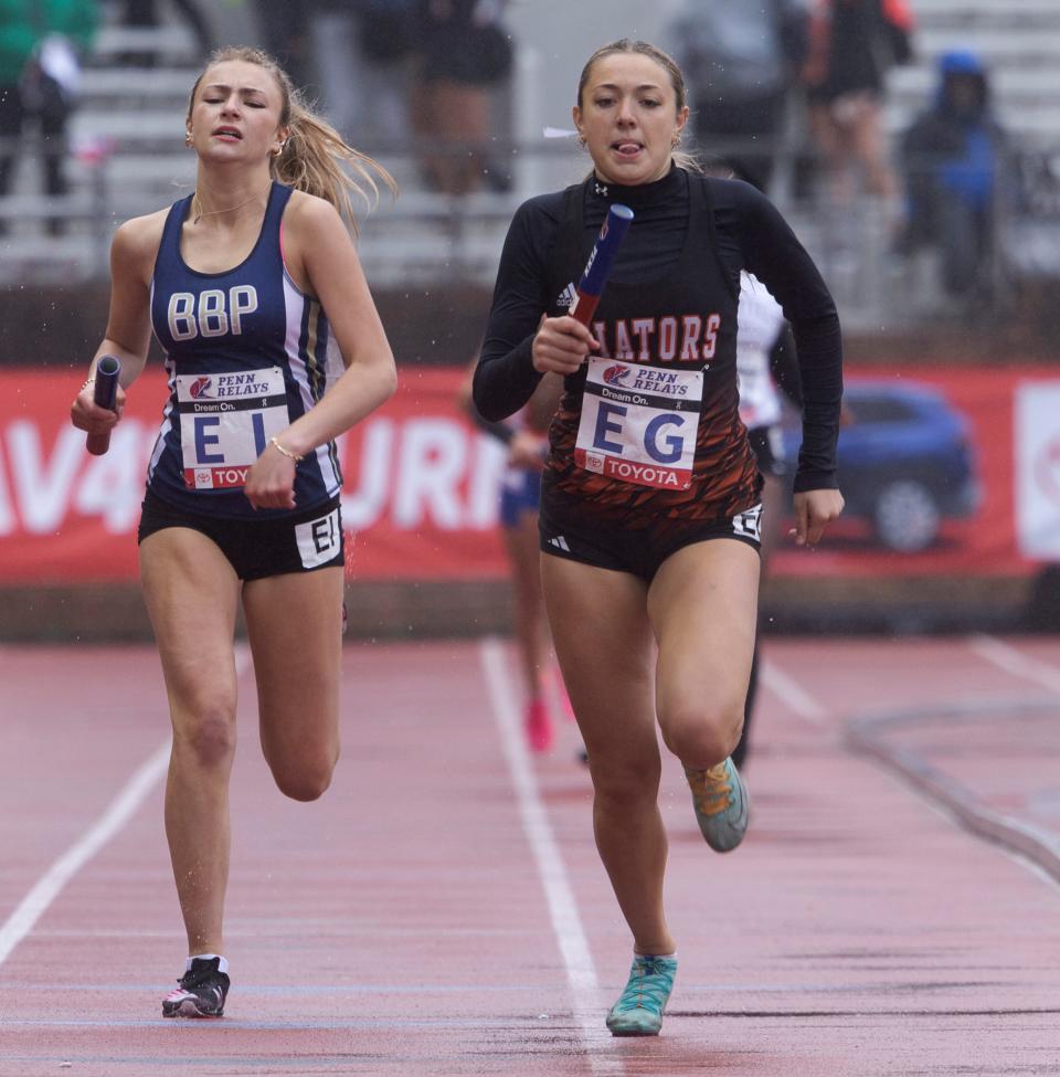 Lexy Samperi of Hasbrouck Heights (EG) holds off the Bayport Blue Point (NY) anchor as the Aviators win their 4-x-400 heat at Penn Relays.
(Photo: Peter Ackerman )