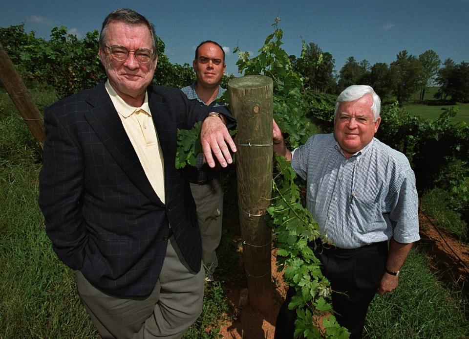 Charlie Shelton, right, is seen at the Shelton Vineyards in 2001. Charlie and brother Ed Shelton, left, launched the vineyards in 1998 on a 200 acres. Also on hand in this file photo is general manager Sean McRitchie.