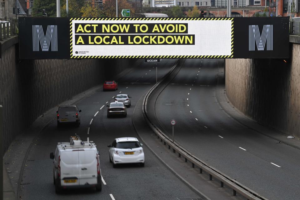 A digital display above a dual carriageway calls on residents to follow coronavirus guidelines in Manchester (AFP via Getty Images)