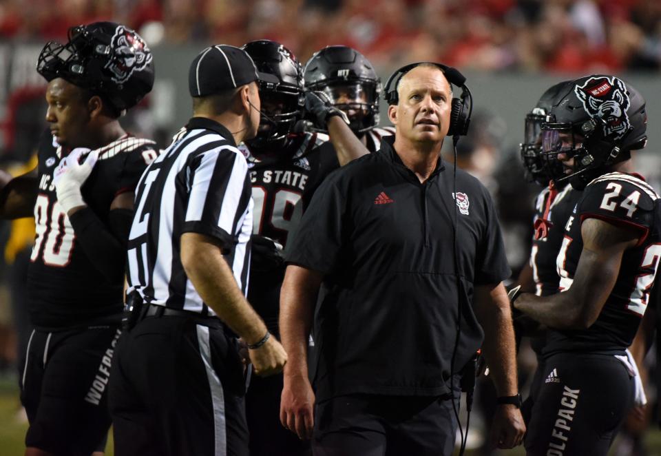 Oct 2, 2021; Raleigh, North Carolina, USA; North Carolina State Wolfpack head coach Dave Doeren watches a replay during the second half against the Louisiana Tech Bulldogs at Carter-Finley Stadium. Mandatory Credit: Rob Kinnan-USA TODAY Sports