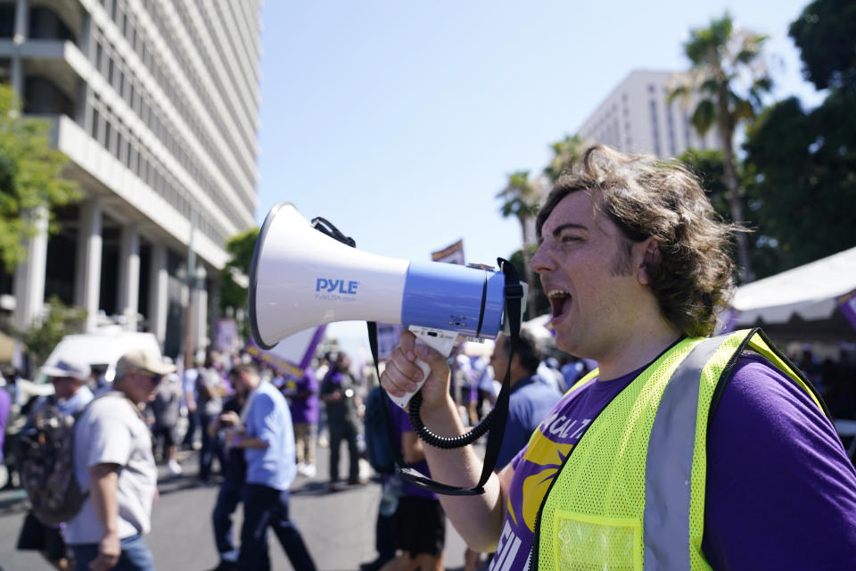 Workers picket outside of City Hall, Tuesday, Aug. 8, 2023, in Los Angeles. Thousands of Los Angeles city employees, including sanitation workers, lifeguards and traffic officers, walked off the job Tuesday for a 24-hour strike alleging unfair labor practices. (AP Photo/Ryan Sun)