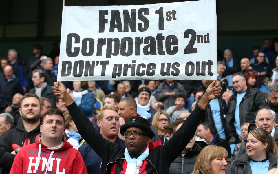 A Manchester City fan makes his feelings clear about the high season ticket prices for their match with Aston Villa on April 25, 2015