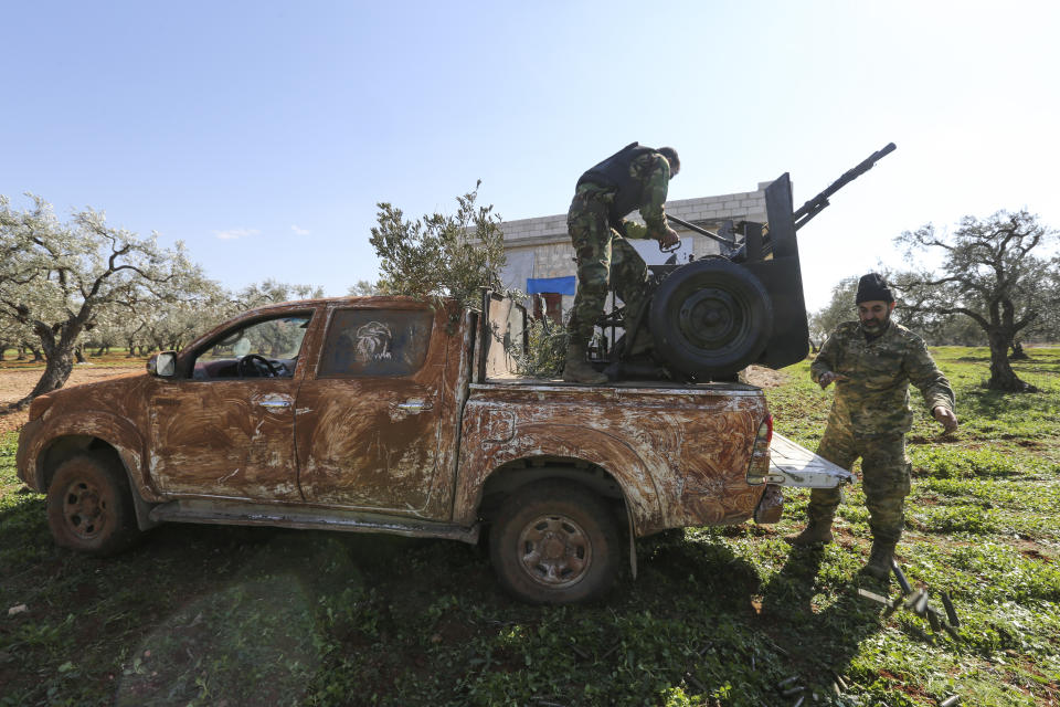 Turkish backed rebel fighters take positions near the village of Neirab in Idlib province, Syria, Thursday, Feb. 20, 2020. Two Turkish soldiers were killed Thursday by an airstrike in northwestern Syria, according to Turkey's Defense Ministry, following a large-scale attack by Ankara-backed opposition forces that targeted Syrian government troops. (AP Photo/Ghaith Alsayed)