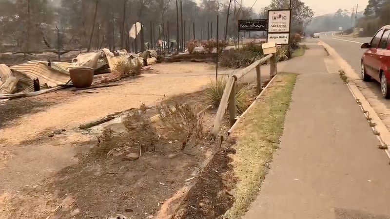 A debris is seen after bushfires heavily damaged stores in Mogo