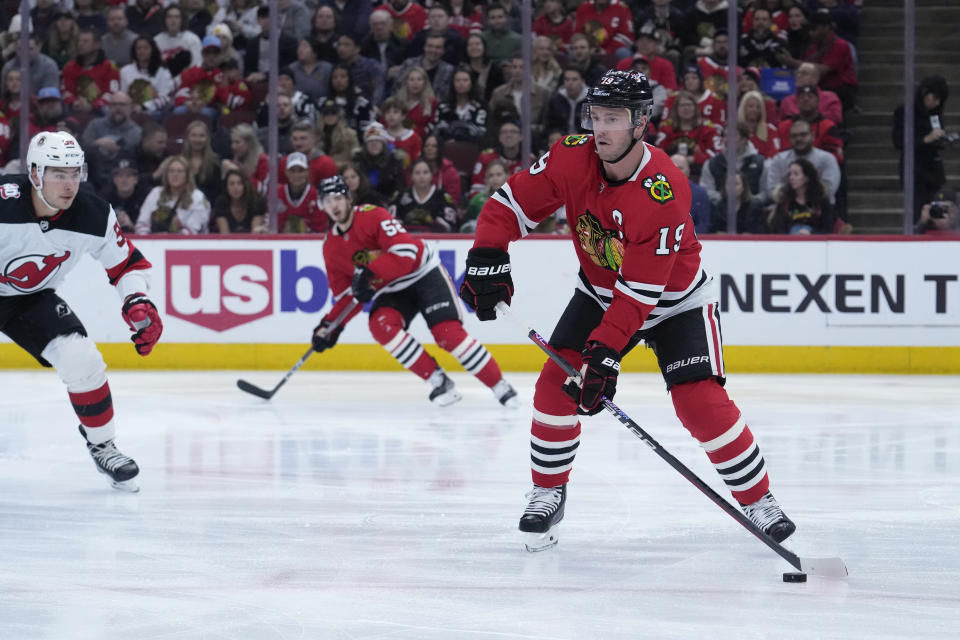 Chicago Blackhawks' Jonathan Toews handles the puck during the first period of the team's NHL hockey game against the New Jersey Devils on Saturday, April 1, 2023, in Chicago. Toews returned from a two-month medical leave of absence. (AP Photo/Charles Rex Arbogast)