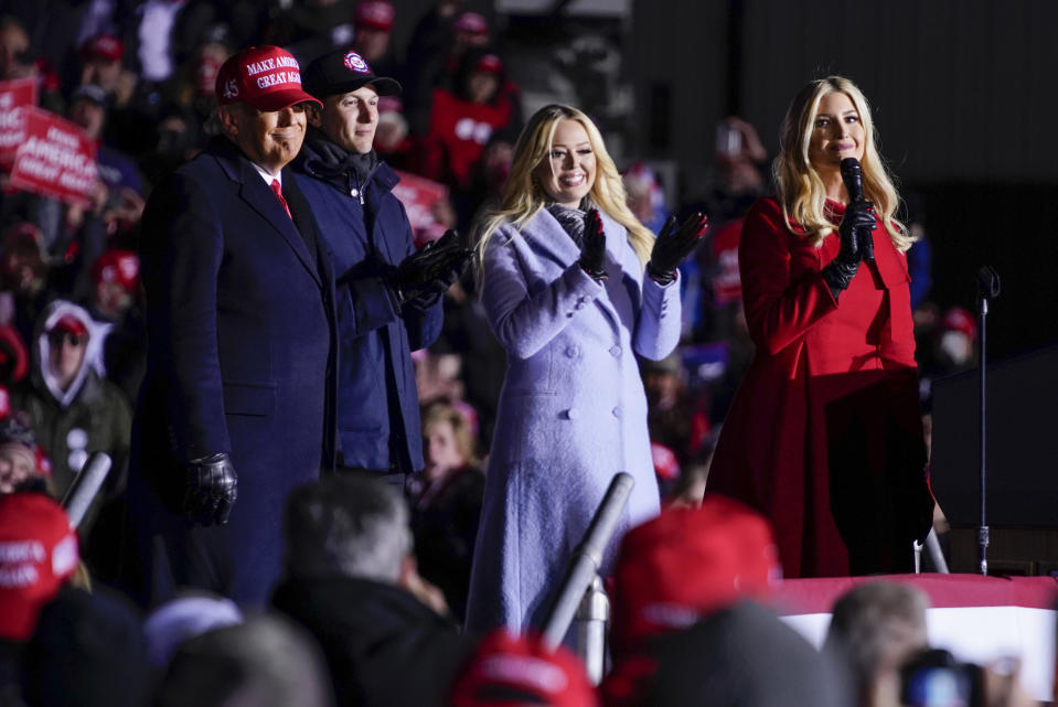 President Donald Trump listens as Ivanka Trump speaks during a campaign rally at Kenosha Regional Airport, Monday, Nov. 2, 2020, in Kenosha, Wis. Listening are Jared Kushner and Tiffany Trump. (AP Photo/Evan Vucci)