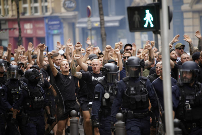 Eintracht Frankfurt fans are escorted by French riot police officers prior to the Champions League soccer match between Olympique de Marseille and Eintracht Frankfurt at the Velodrome stadium in Marseille, south of France, Tuesday, Sept. 13, 2022. (AP Photo/Daniel Cole)