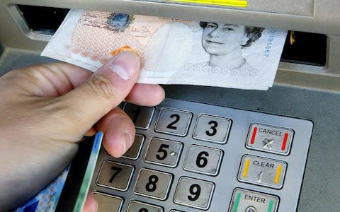 The amount of money being withdrawn from cash points is expected to halve over the next decade - Credit: Gareth Fuller/PA