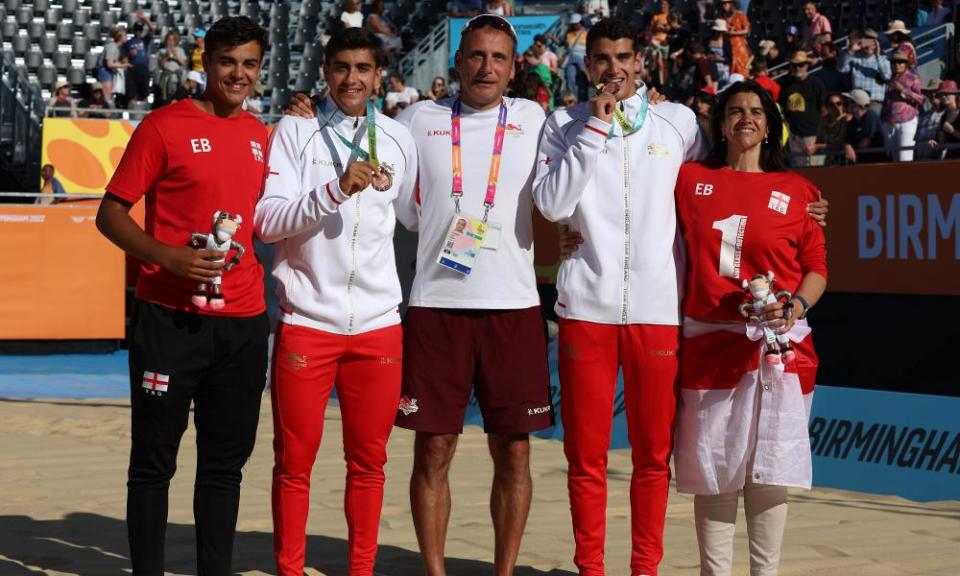 Javier Bello and Joaquin Bello celebrate bronze in the beach volleyball with family members