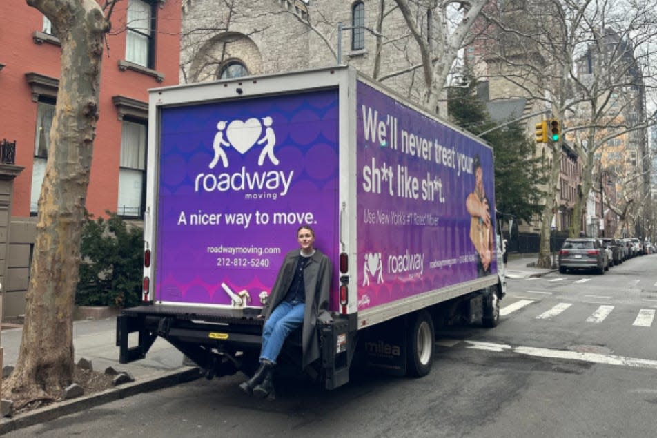 Hayley Folk sitting on a moving truck.