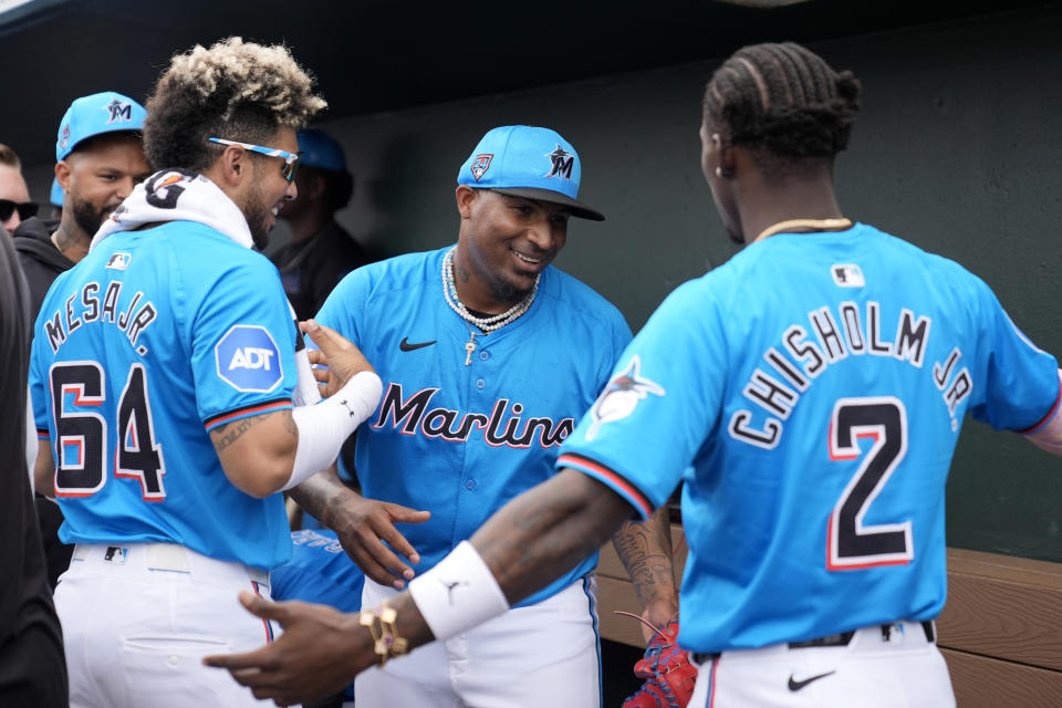 Miami Marlins' Sixto Sanchez is congratulated by teammates Victor Mesa Jr. (64) and Jazz Chisholm Jr. (2) after pitching the fifth inning of a spring training baseball game against the New York Mets Saturday, March 2, 2024, in Jupiter, Fla. (AP Photo/Jeff Roberson)